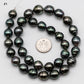 Displaying strand number 1, Tahitian Pearl drop in full strand next to a US dime coin.