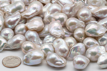 Loose Freshwater Baroque Pearl next to a US dime coin.