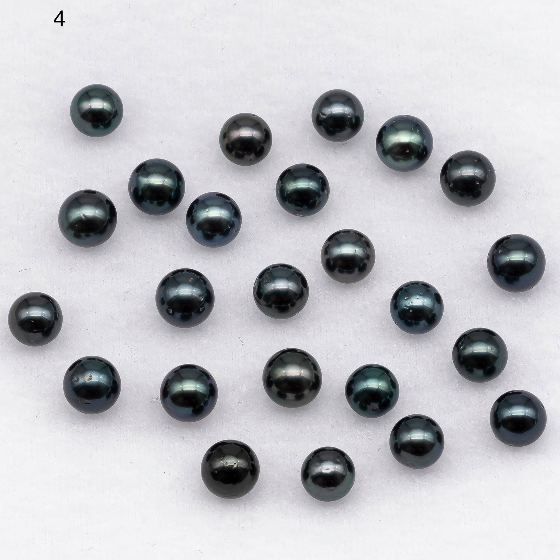 Dark color loose round shape Tahitian Pearl with blemishes