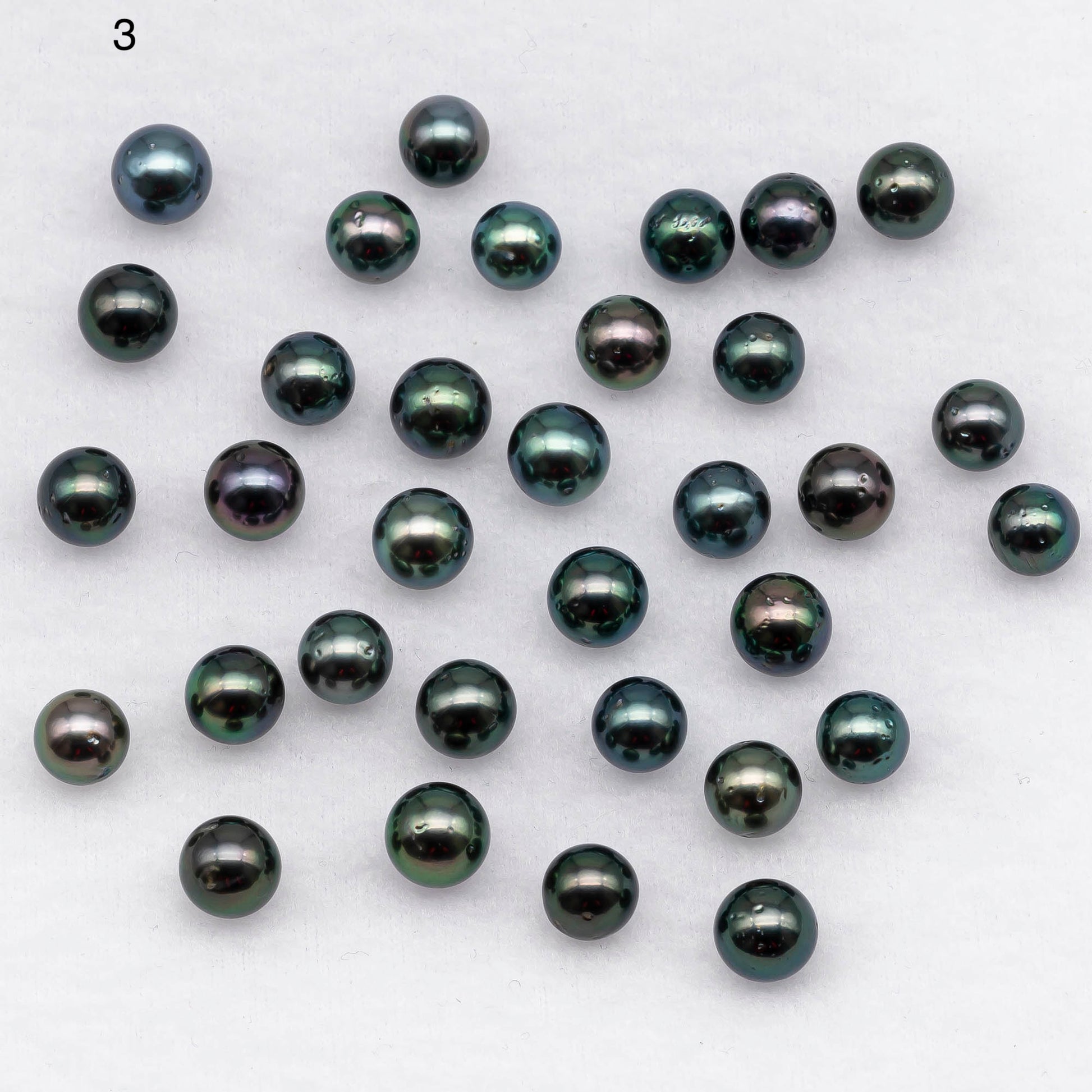 Round Tahitian Pearl loose undrilled in peacock colors with blemishes