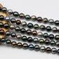 Tahitian Pearl in multi color stand display on top of a circle wood.