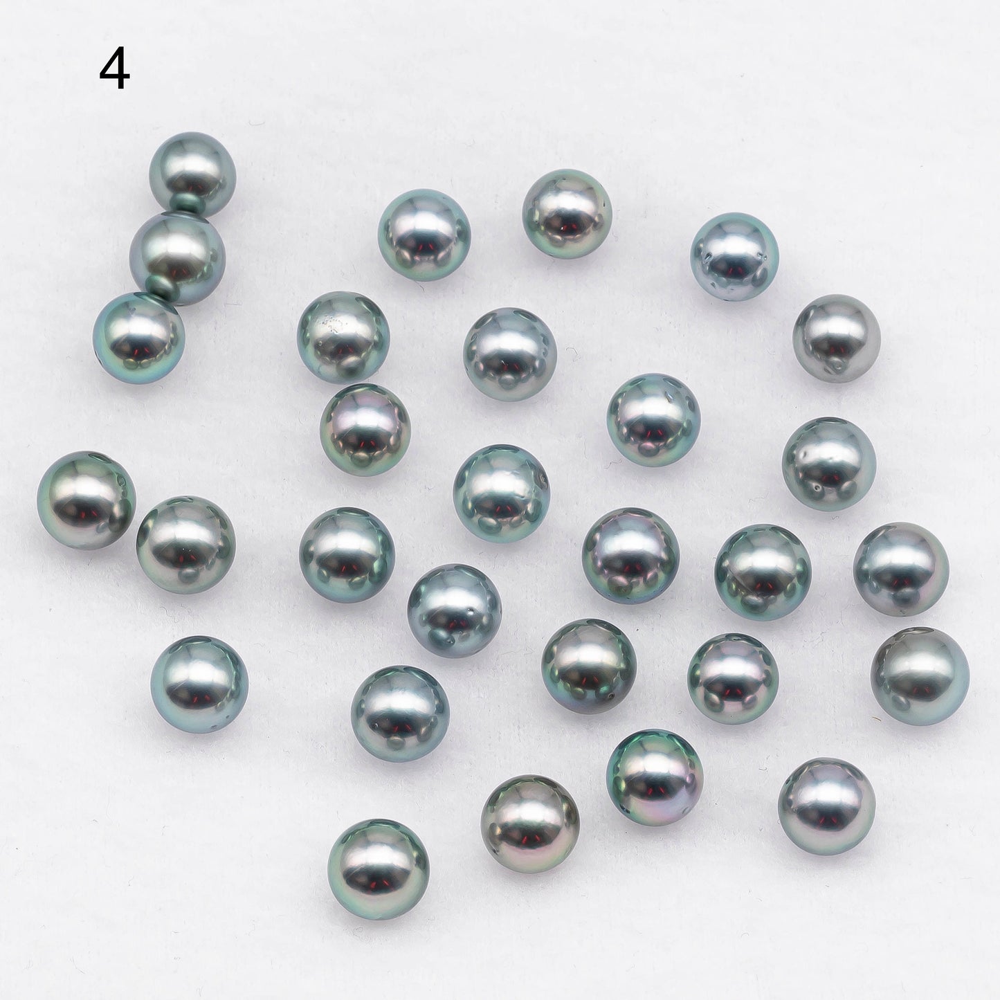 Choose number 4, loose Tahitian Pearl round shape in silver green overtone with lesser blemishes.