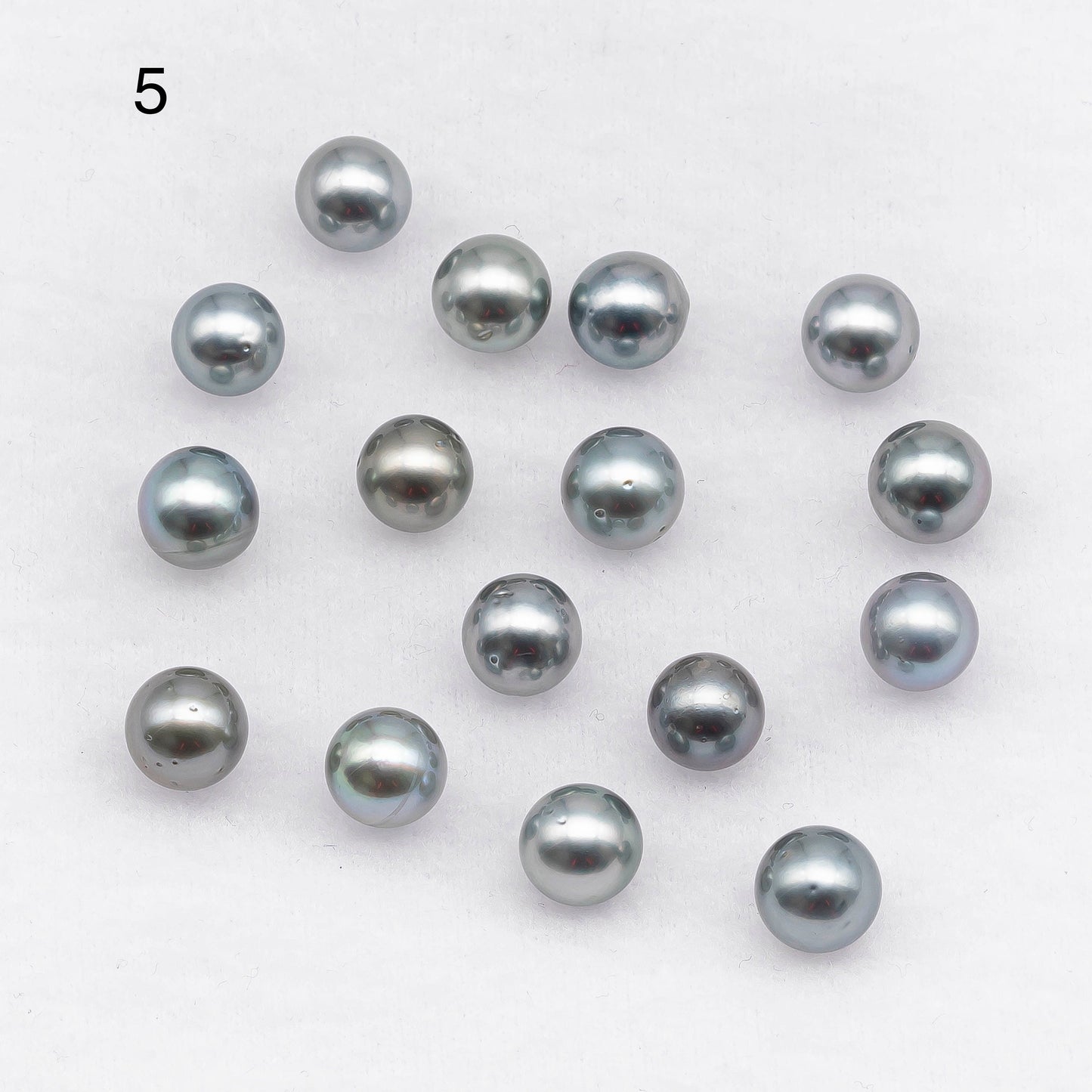 Picture 5, round loose Tahitian Pearl in natural gray colors with blemishes.