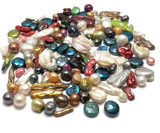 assorted freshwater pearls in different sizes, colors and shape.